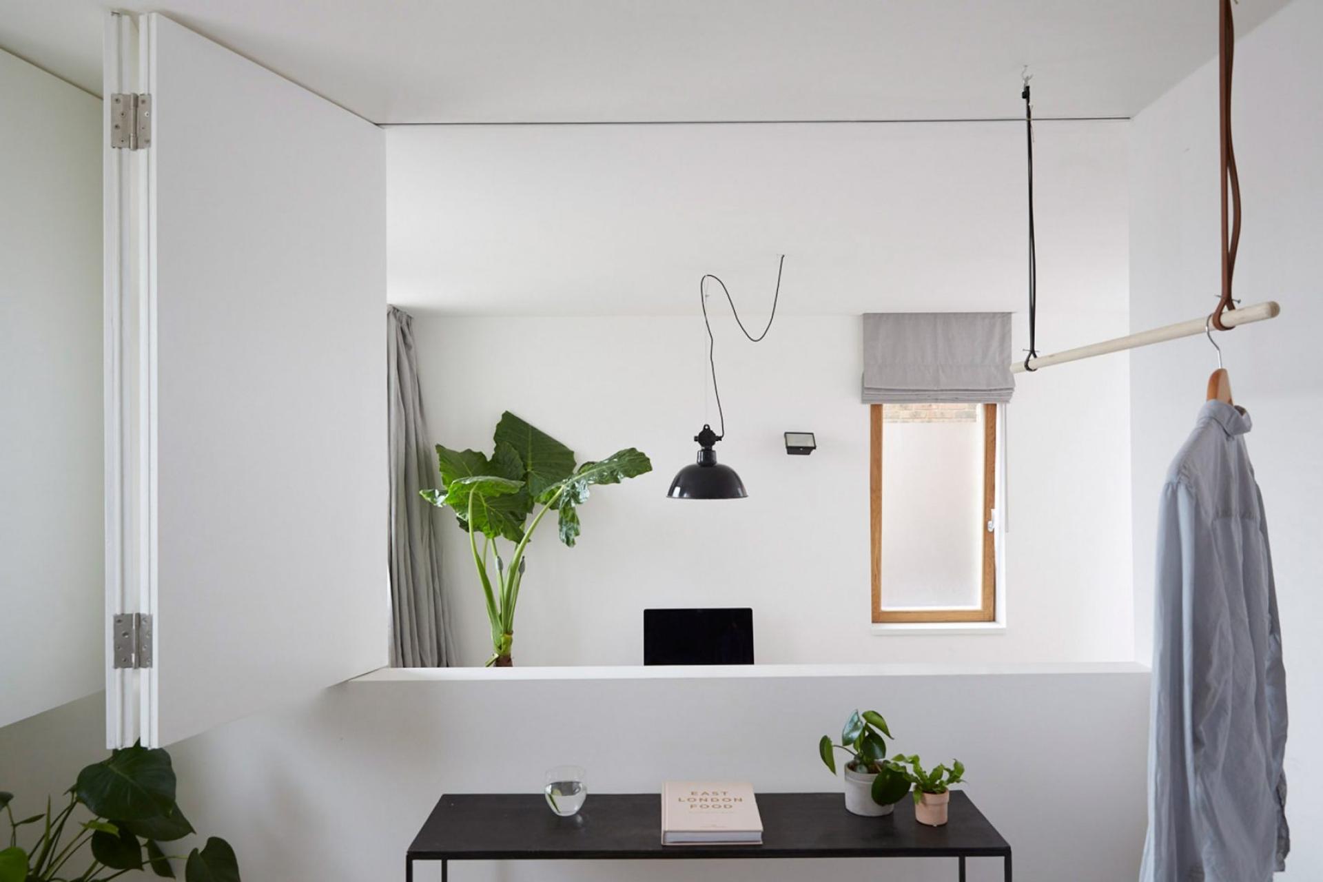 Contemporary mews house interior featuring minimal design, greenery, workspace, and natural light in Hackney, London.