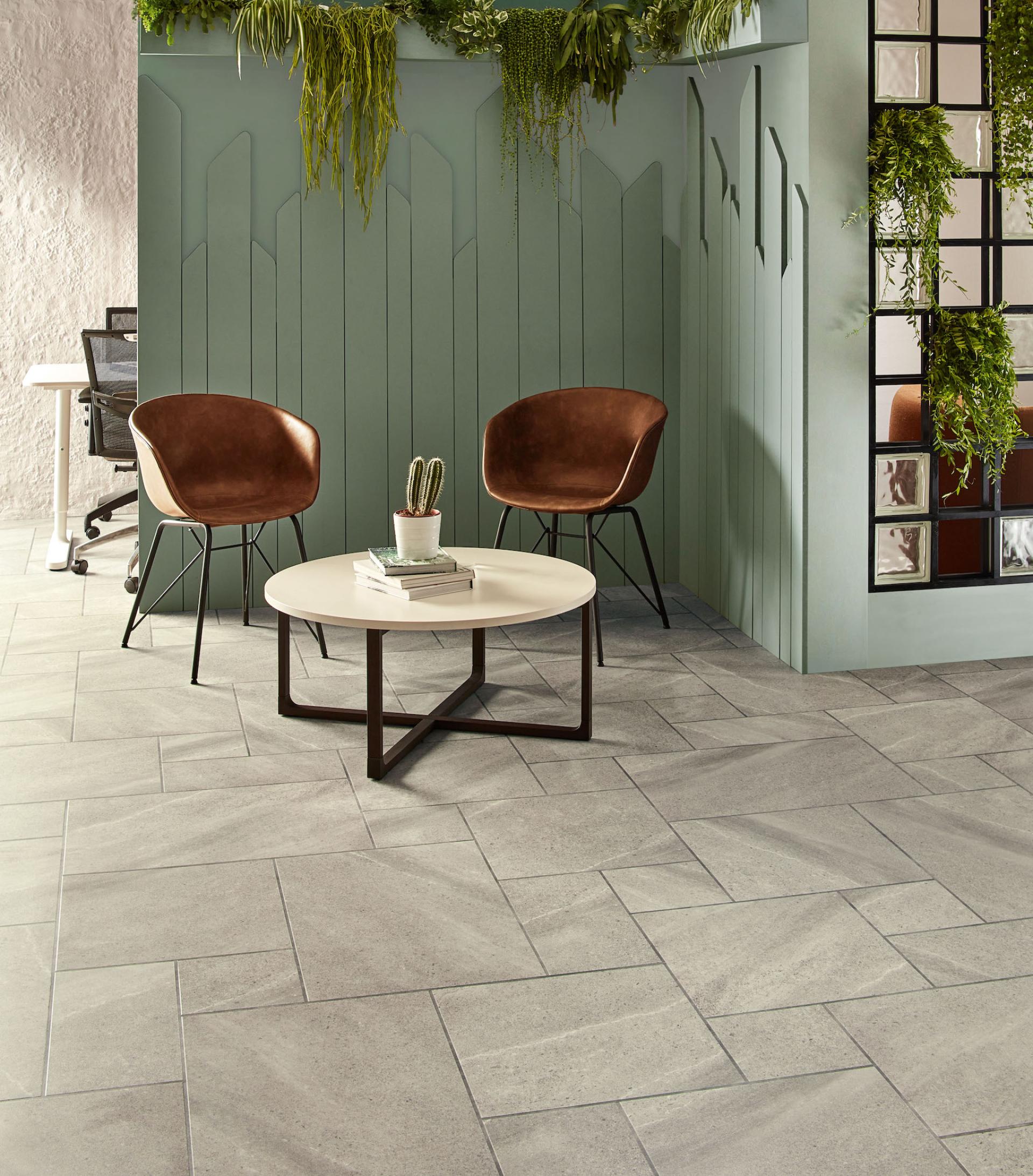 Stylish interior featuring Amtico Bio lower carbon flooring, modern decor, and potted plants creating a sustainable workspace.