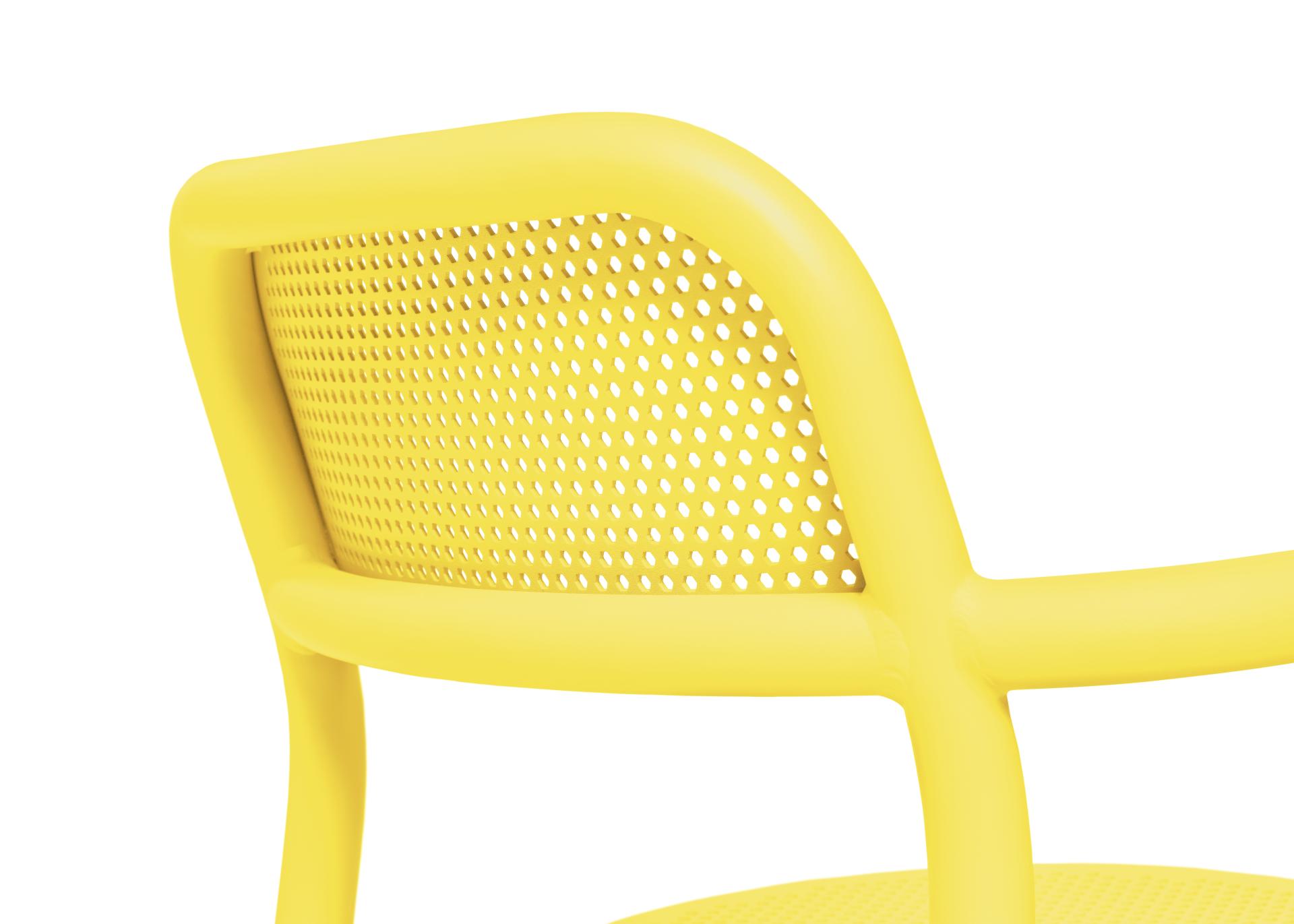 Bright yellow perforated chair showcasing playful design, embodying the vibrant color palette trends from Dutch Design Week 2023.
