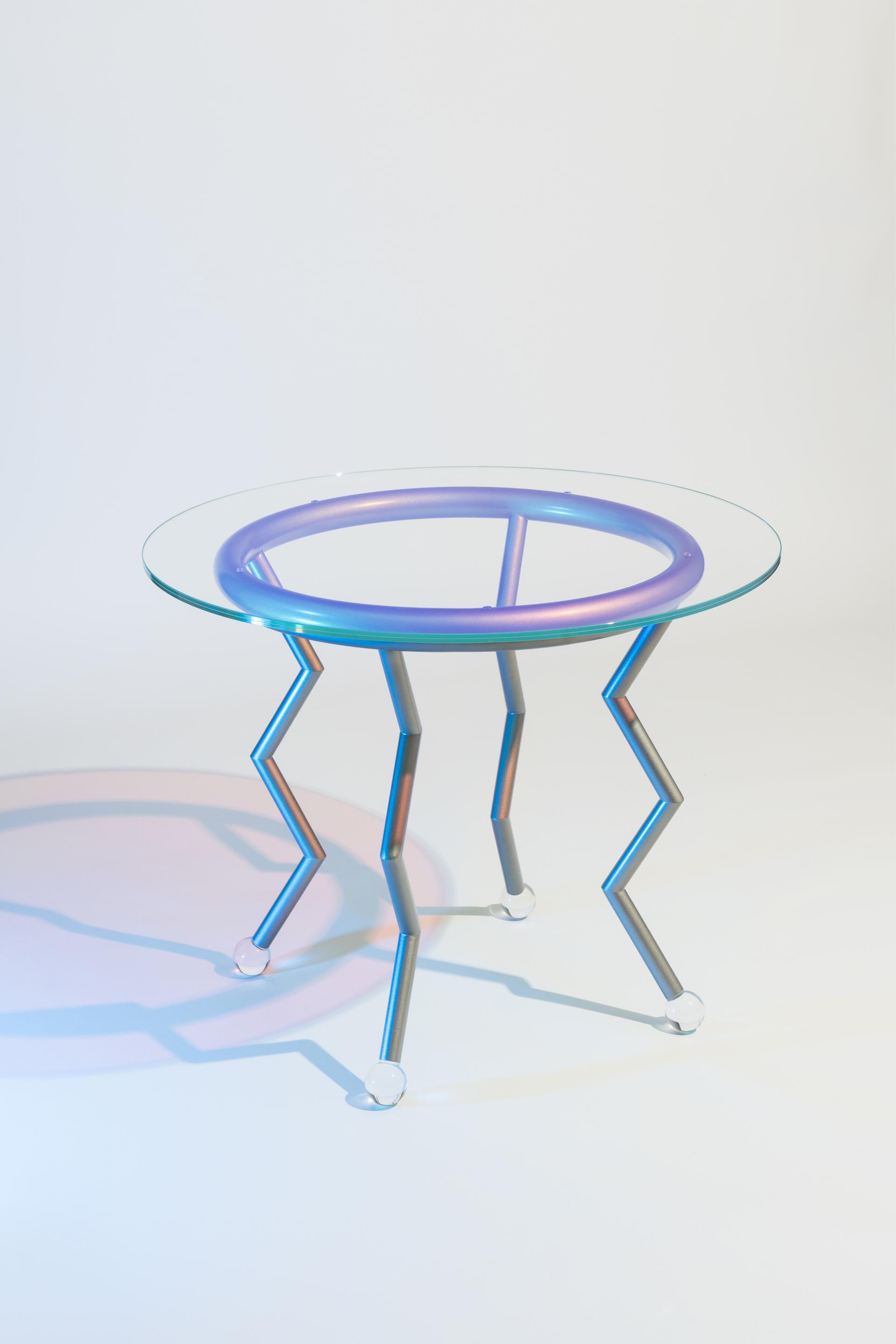 Colorful zigzag table with a glass top, showcasing playful design elements inspired by the Memphis movement.