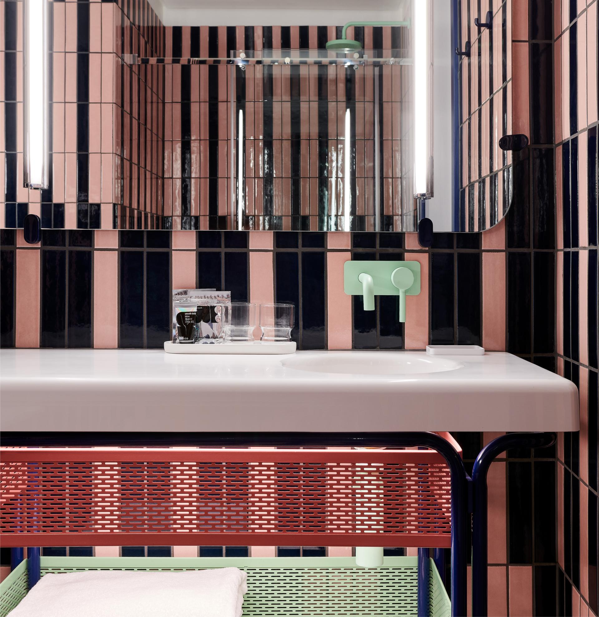 Stylish bathroom sink featuring colorful tiled walls, modern fixtures, and a contemporary design at The Standard, London.