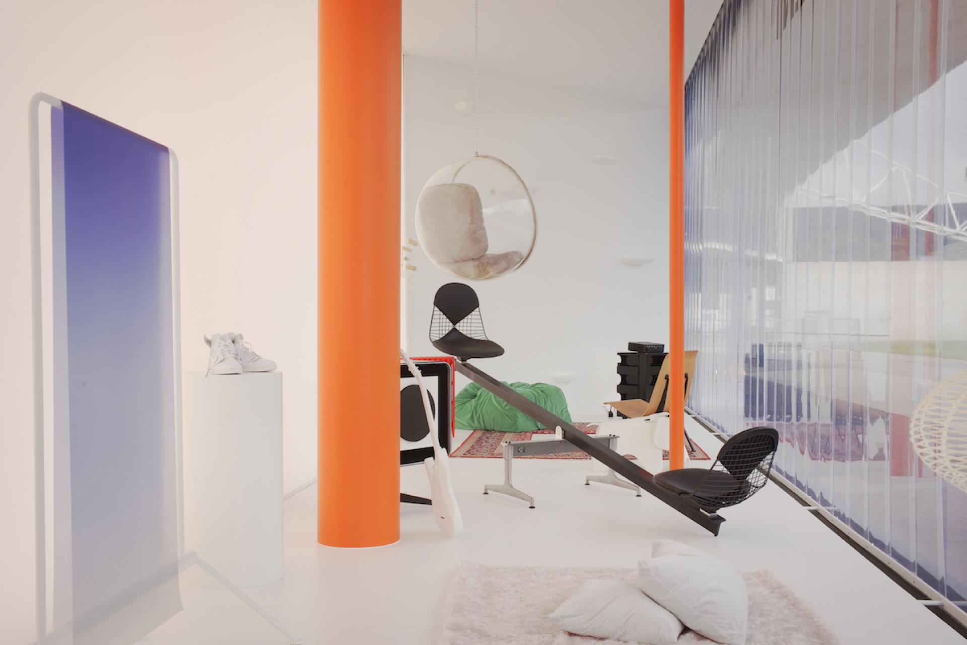 Futuristic interior featuring Vitra's collaboration with Virgil Abloh, showcasing modern furniture and vibrant design elements.