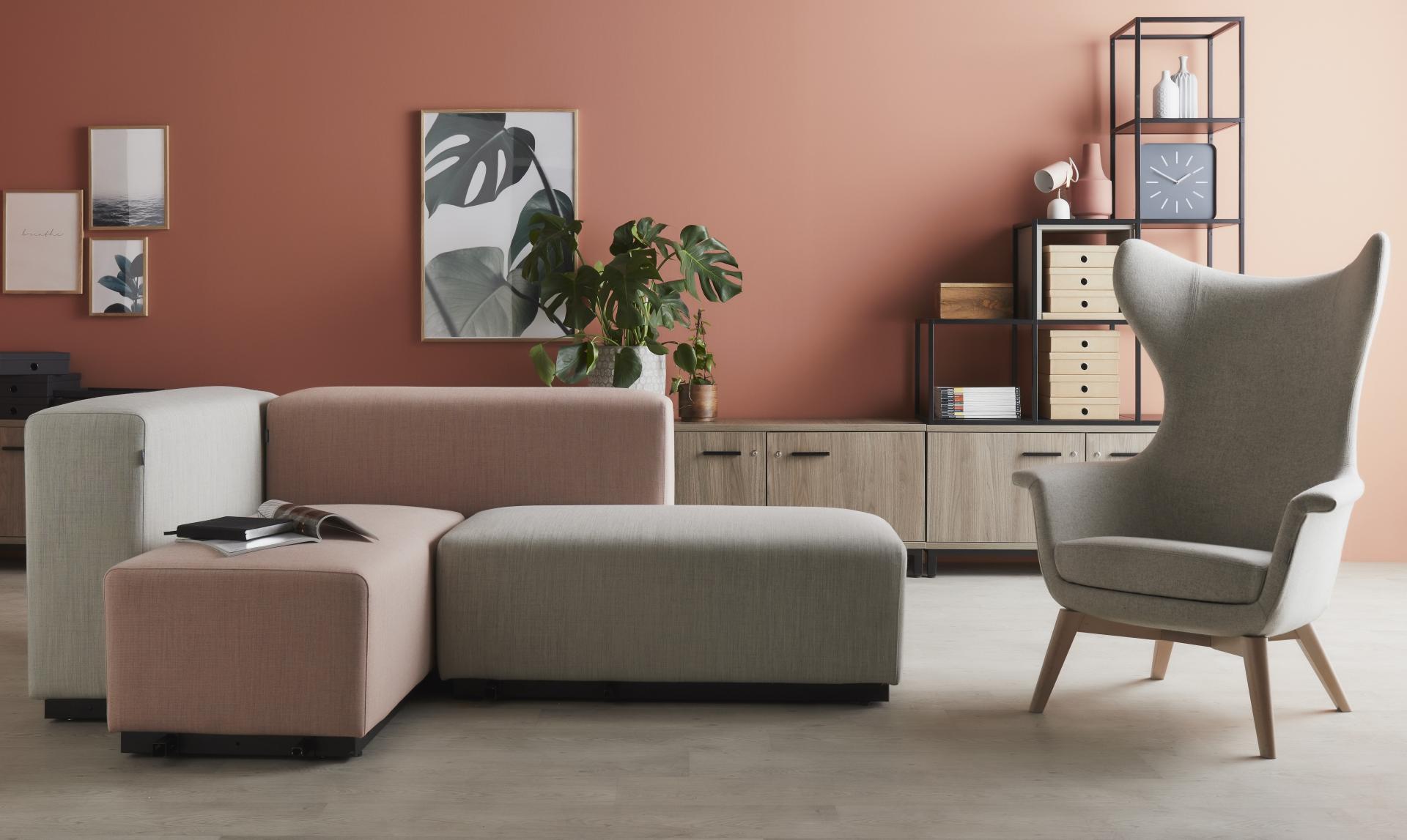 Modern living room featuring stylish furniture by Gresham, highlighting a unique sofa and designer armchair against a warm backdrop.