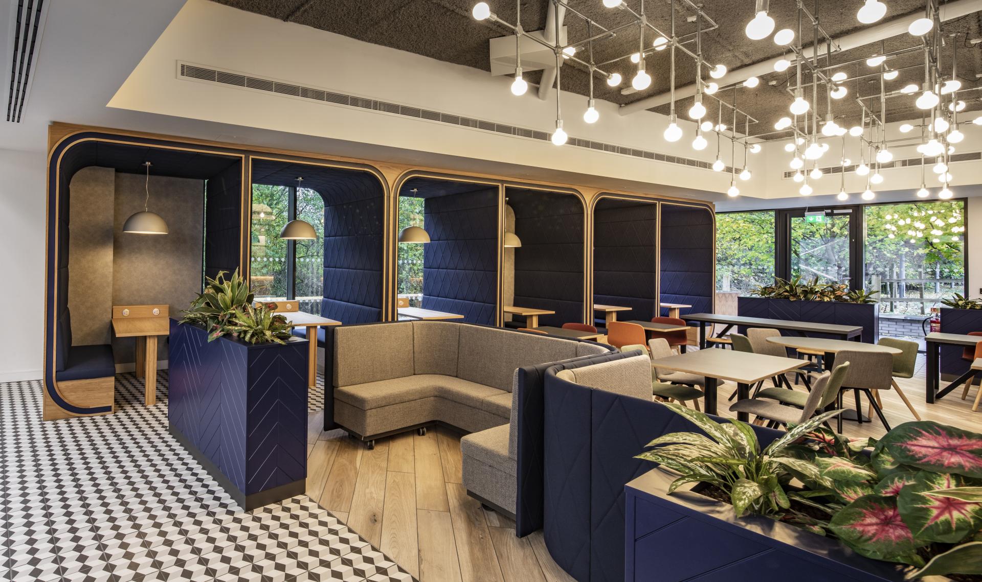 Modern interior design featuring cozy seating areas and natural light at SpaceInvader, showcasing local artistic elements and creative space.