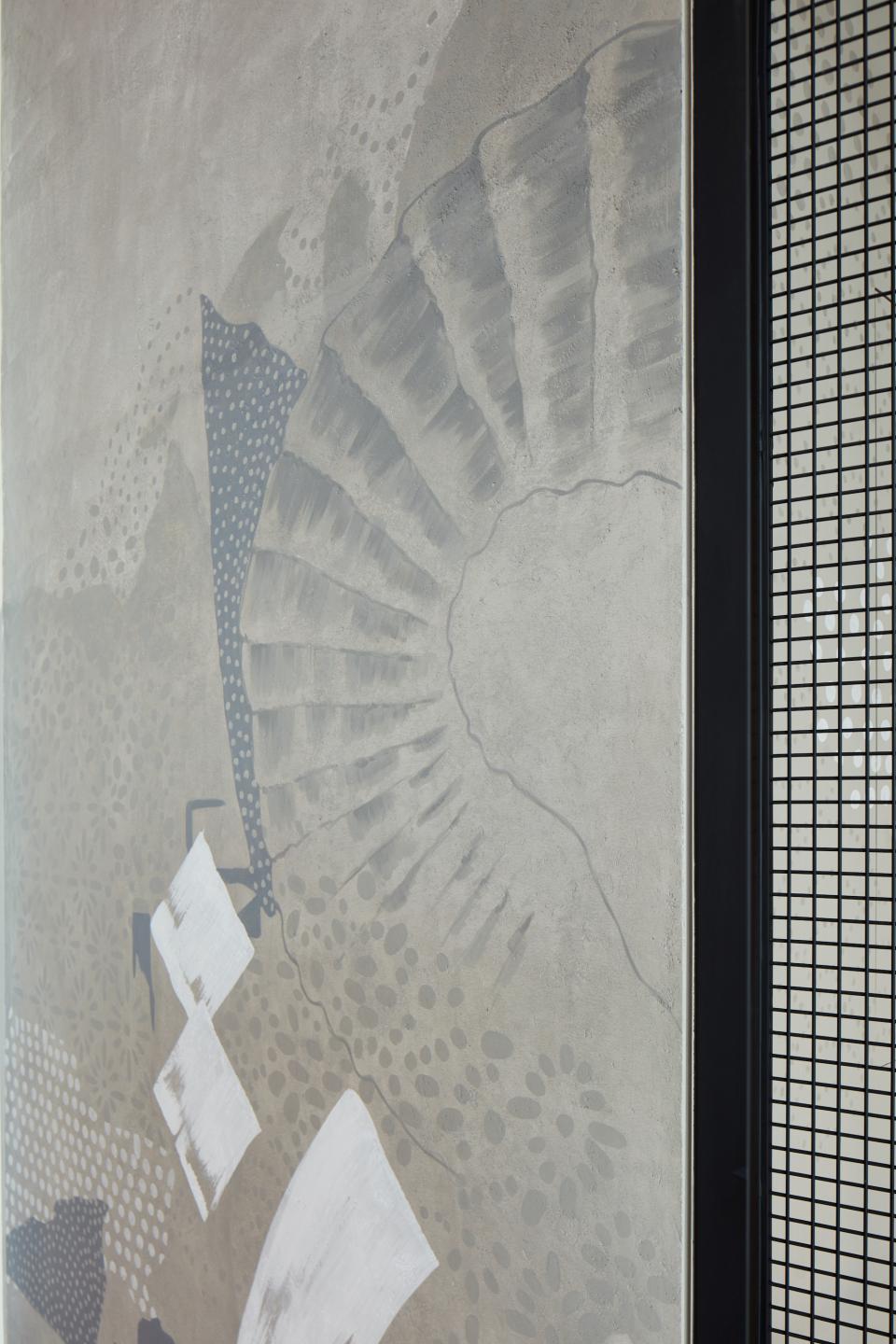 Textured wall art featuring organic patterns and muted colors, enhancing the contemporary design of Origami restaurant in Dubai.