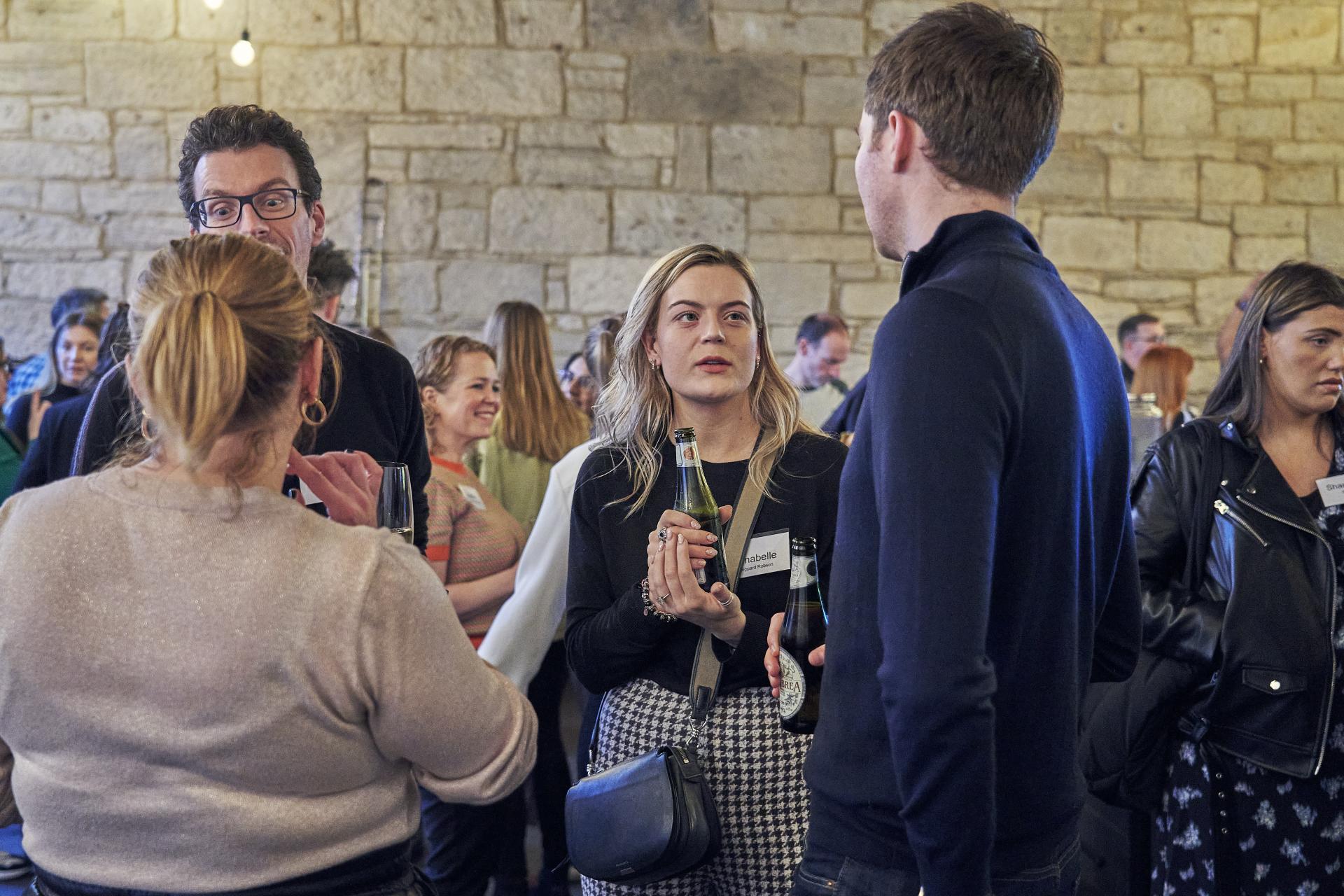 Attendees engage in discussion about sustainability at Material Source Studio event in Glasgow, fostering community and dialogue.