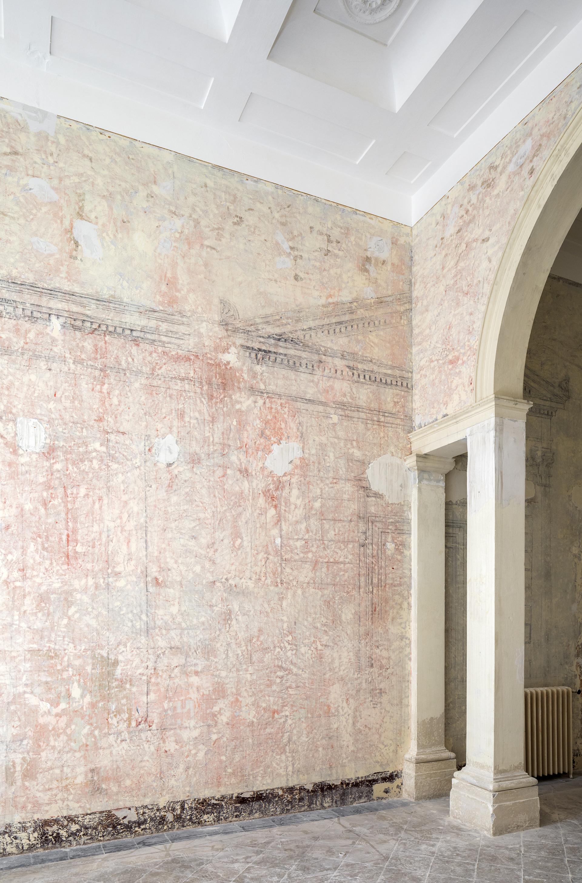 Interior of Palazzo Brancaccio featuring textured pastel walls and architectural columns, highlighting Contemporary Cluster's design focus.