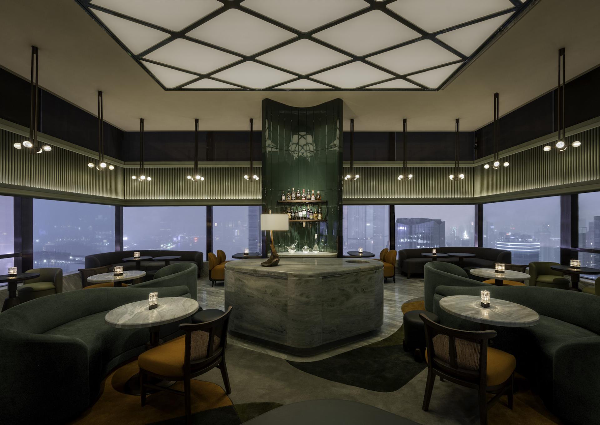 Elegant Art Deco bar area in The Upper House, Hong Kong, featuring stylish seating, dim lighting, and panoramic city views.