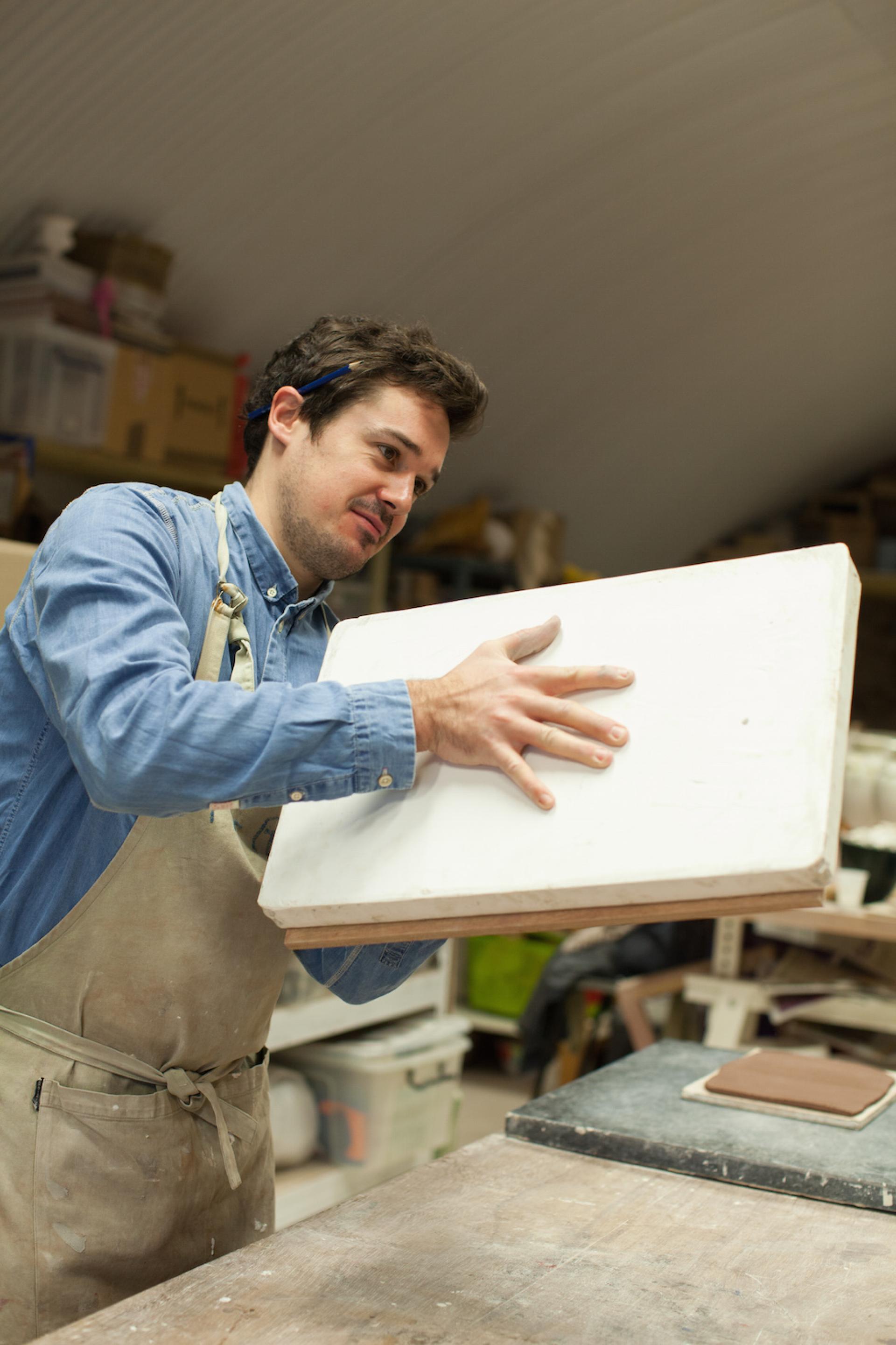 Ceramic artist Matthew Raw working with clay in his studio, showcasing creativity and craftsmanship in post-industrial Manchester.