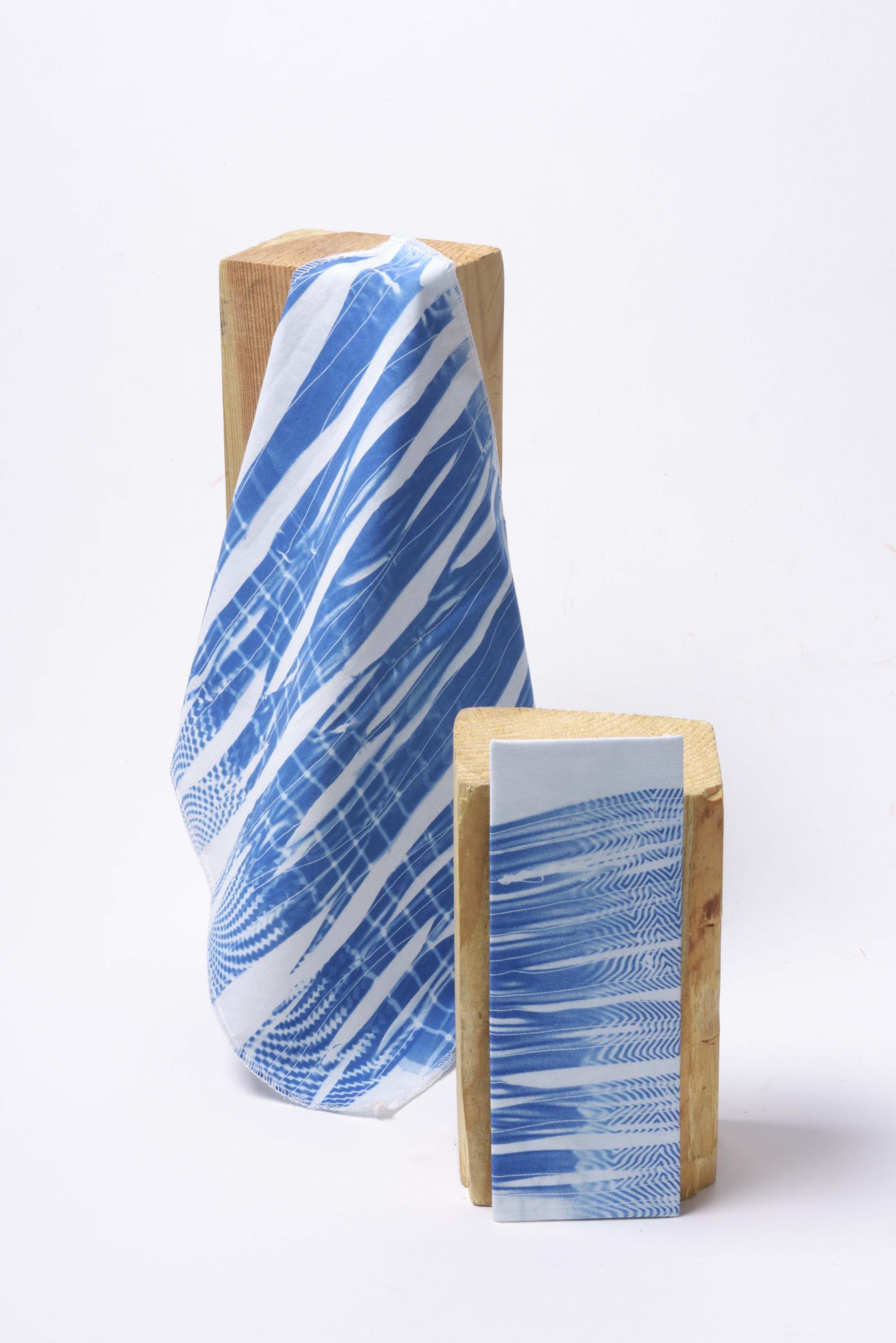 Textile showcasing sustainable innovations with blue patterns displayed on wooden blocks at Munich Fabric Start event.