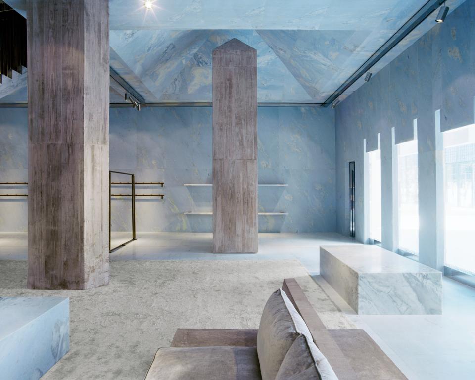 Céline's Miami store interior features blue marble surfaces, sculptural pyramid structures, and minimalist design elements by Valerio Olgiati.