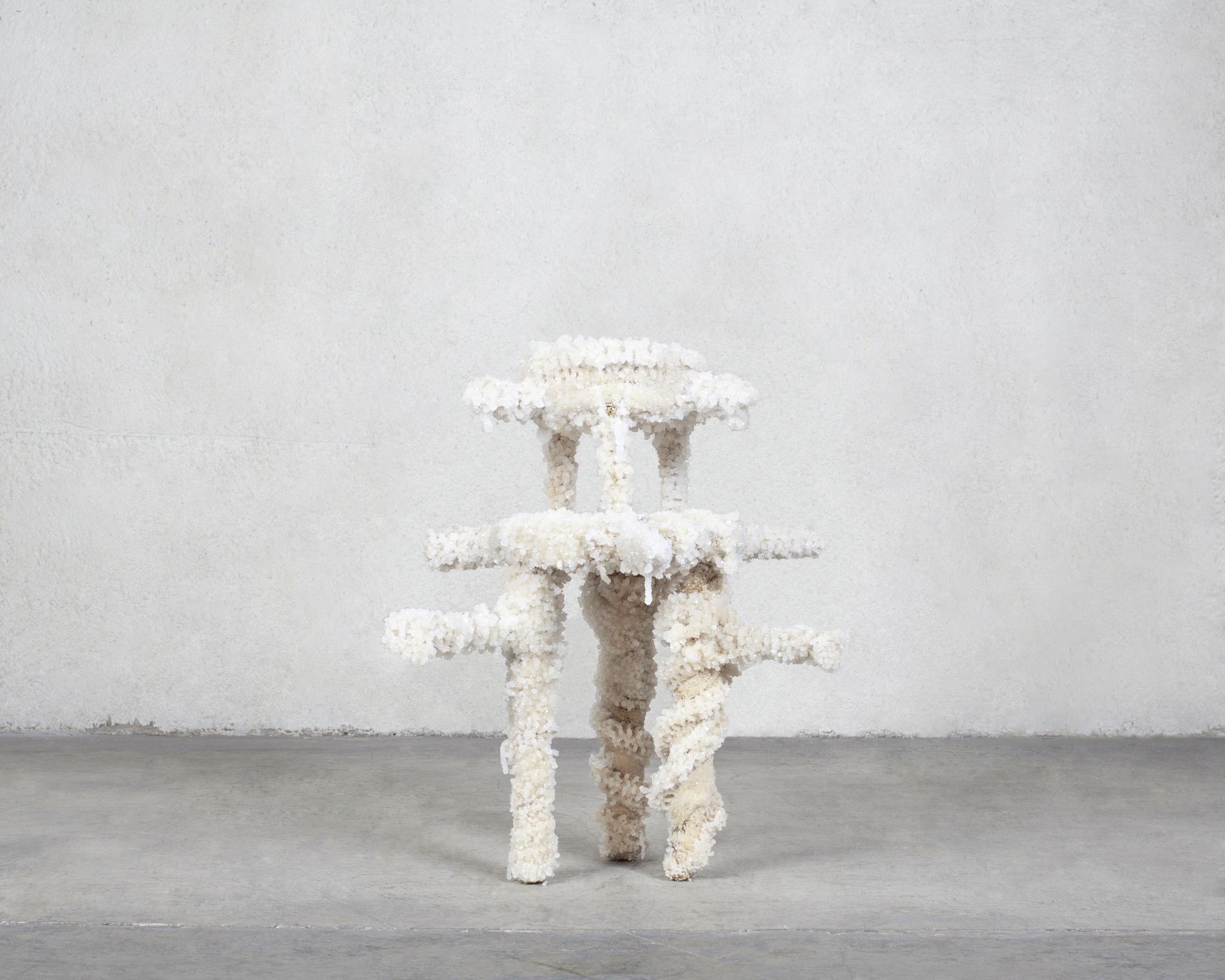 Sculptural vegan furniture made from Dead Sea minerals, featuring a unique, textured design in a minimalist setting.