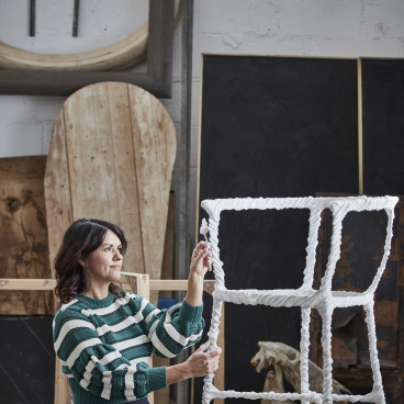 Artisan craftsman working on a uniquely designed white chair in a creative studio for London Craft Week 2019.