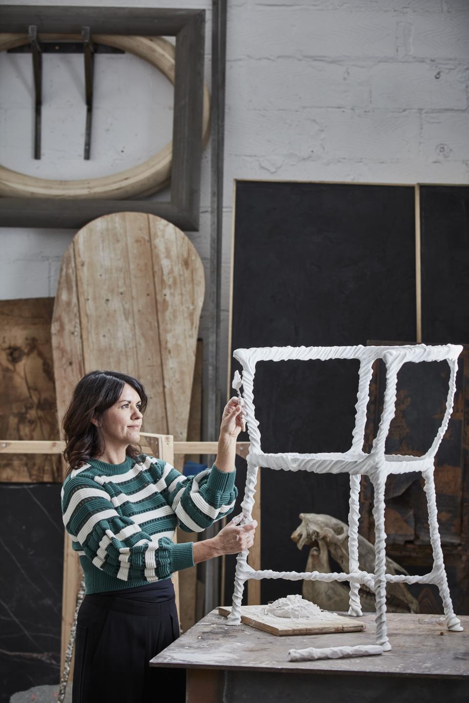 Artisan craftsman working on a uniquely designed white chair in a creative studio for London Craft Week 2019.