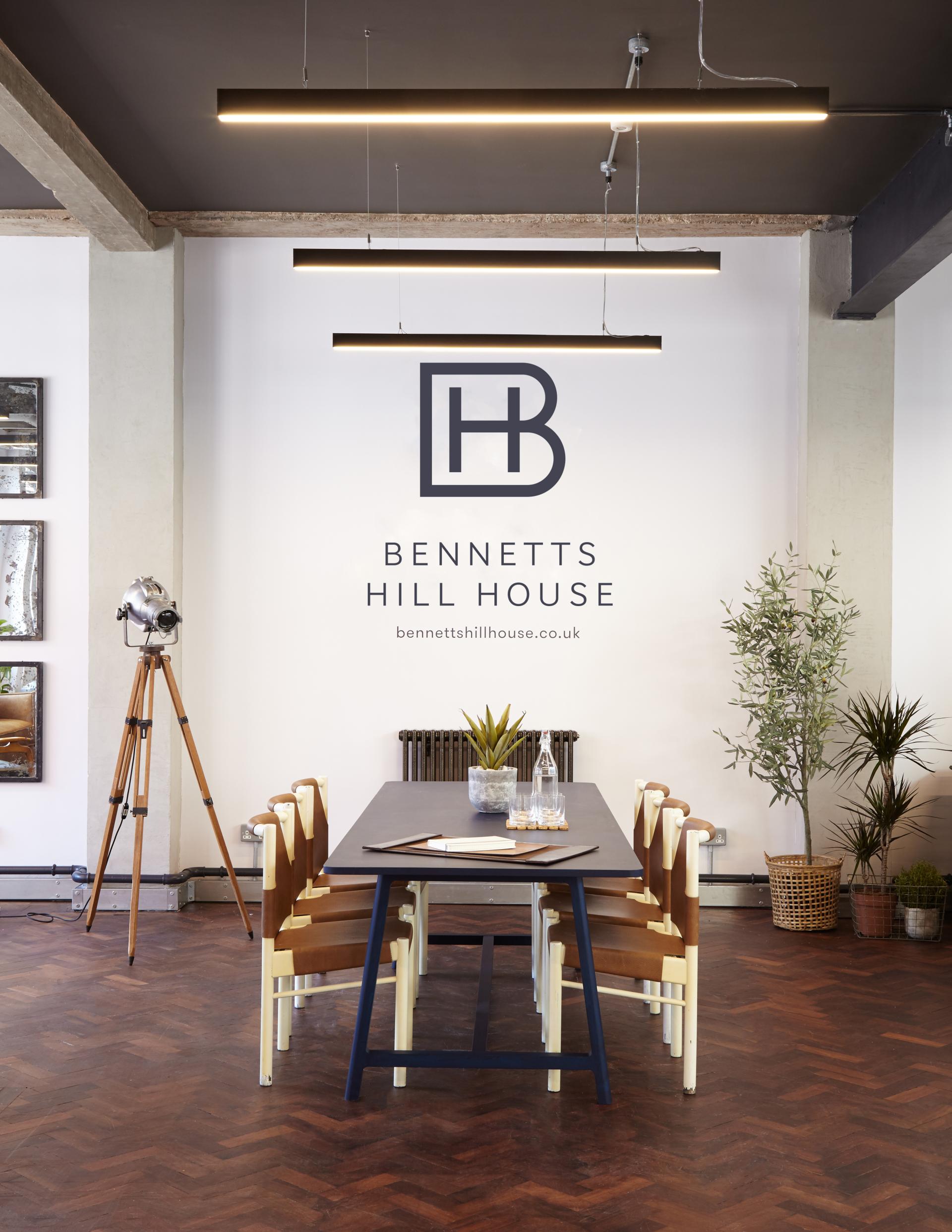 Chic loft-style office space featuring a modern dining table, stylish chairs, and contemporary decor in Bennetts Hill House.