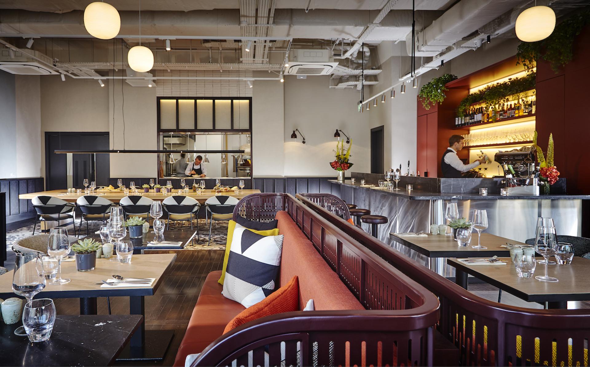 Stylish restaurant interior at The Mont Hotel in Dublin featuring modern furnishings and an inviting bar area.