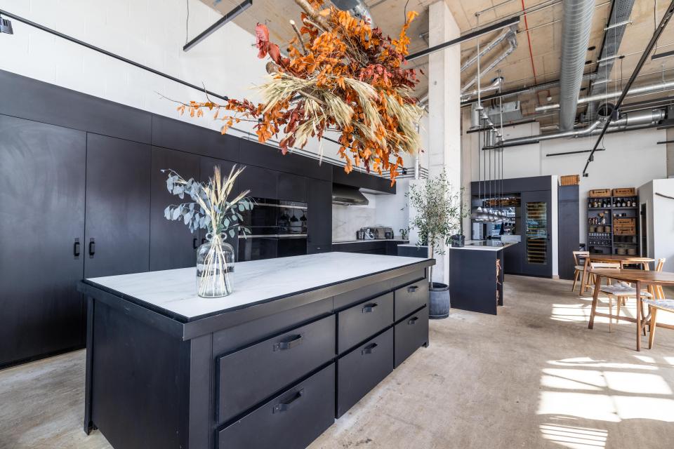 Stylish East London restaurant kitchen featuring Dekton® surfaces, modern cabinetry, and decorative floral arrangements.