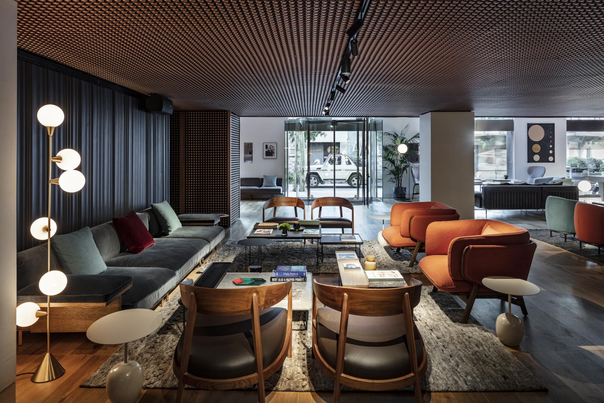 Contemporary lobby of Sir Victor Hotel in Barcelona, featuring stylish seating and modern decor, embodying Catalan lifestyle.