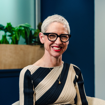 Anna Campbell-Jones smiles during an interview at Material Source Studio in Glasgow, showcasing her design expertise and vibrant personality.