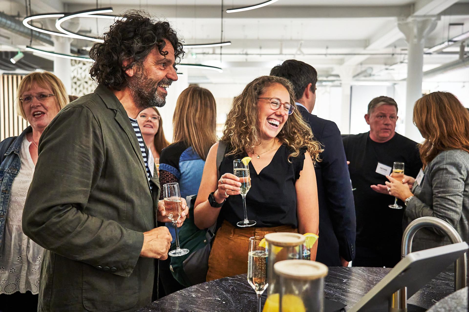 Guests enjoy drinks and engage in conversation during the 42 Gathering event celebrating the podcast on built environment roles.