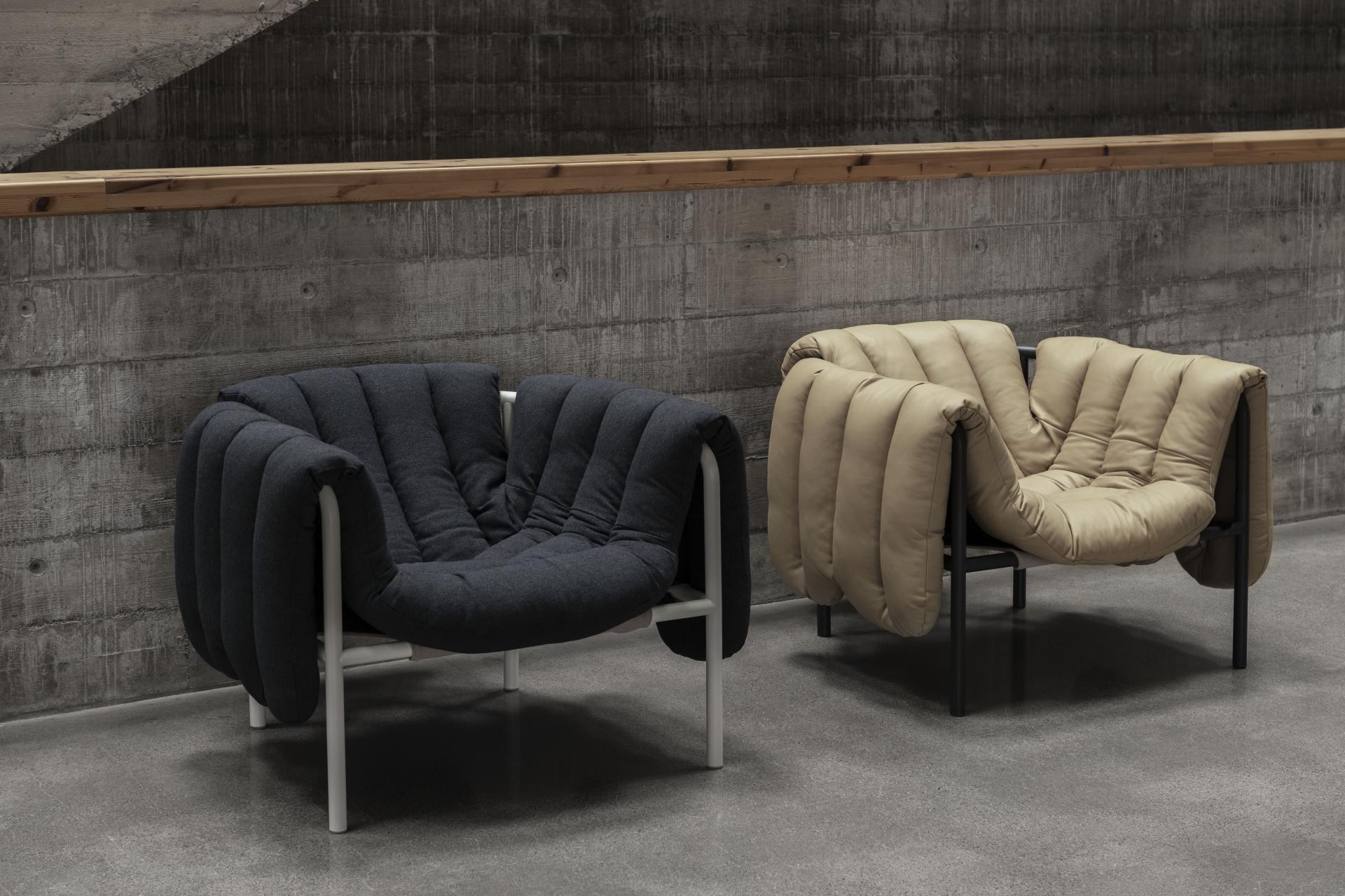 Puffy Lounge Chairs by Toogood, showcasing a unique design with plush upholstery in dark and light colors against a concrete backdrop.