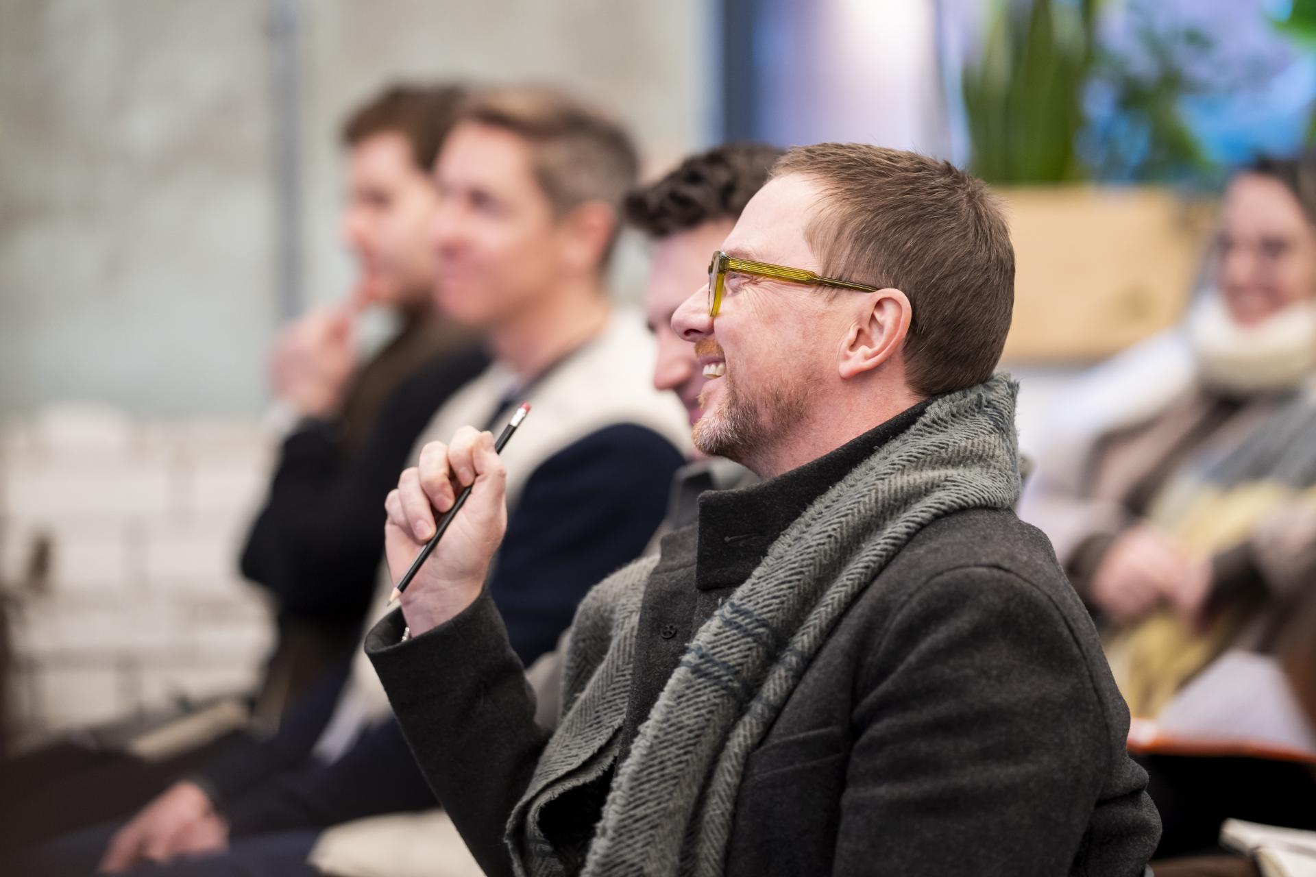 Attendees engaged in a discussion about graphene technology at an event hosted by the Graphene Engineering Innovation Centre.