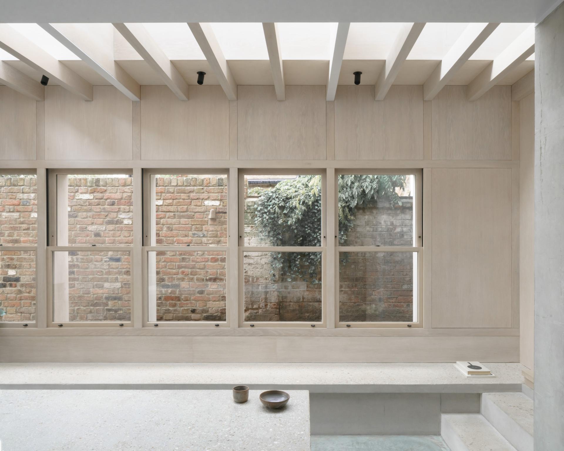Stylish interior view of the Concrete Plinth House, highlighting its modern design and natural light.