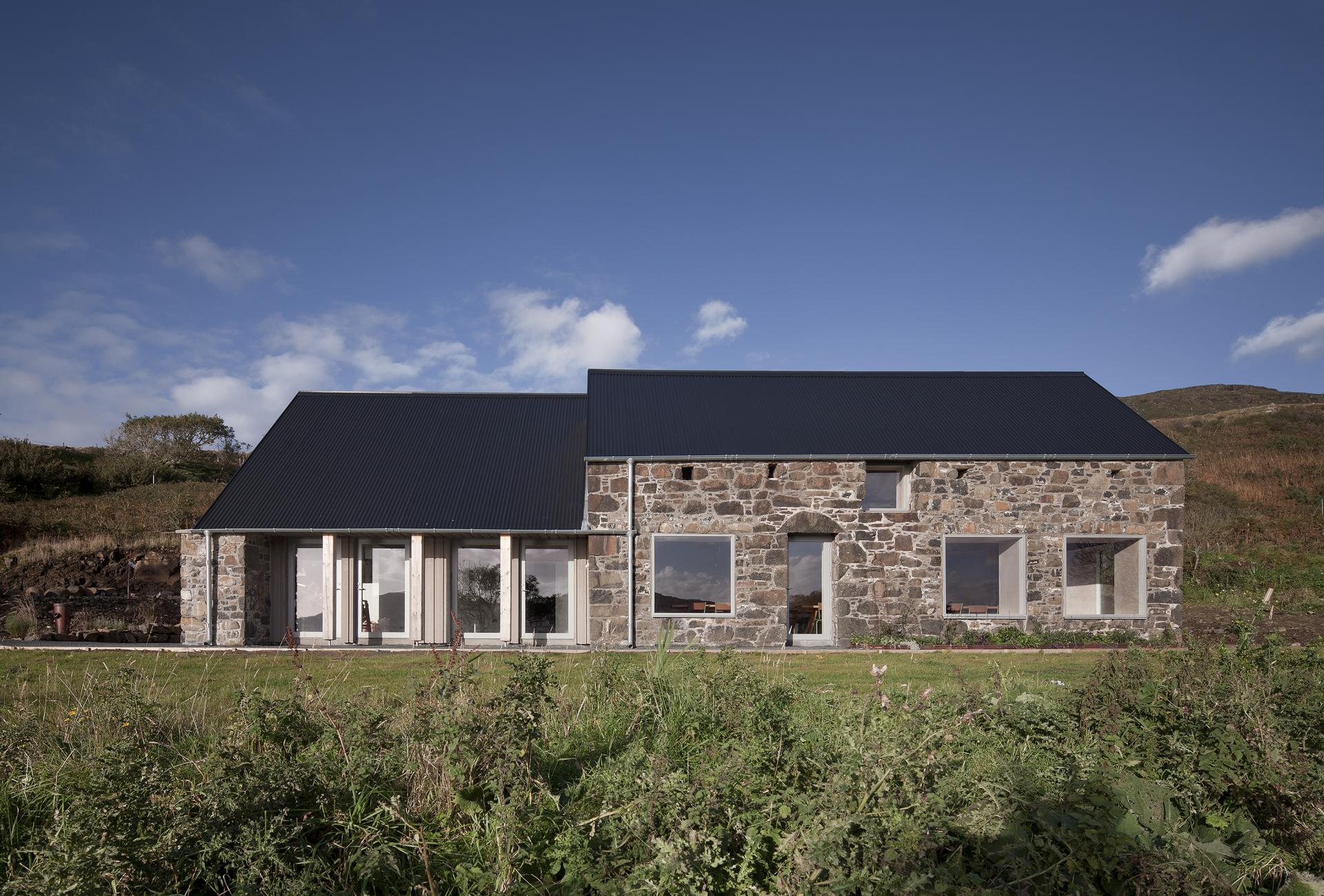 Restored stone croft on the Isle of Mull, showcasing modern architectural retrofitting and scenic surroundings by fardaa Architects.