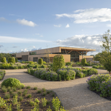 Elegant RHS Bridgewater building surrounded by lush gardens and winding pathways showcasing Allgood's Modric range.