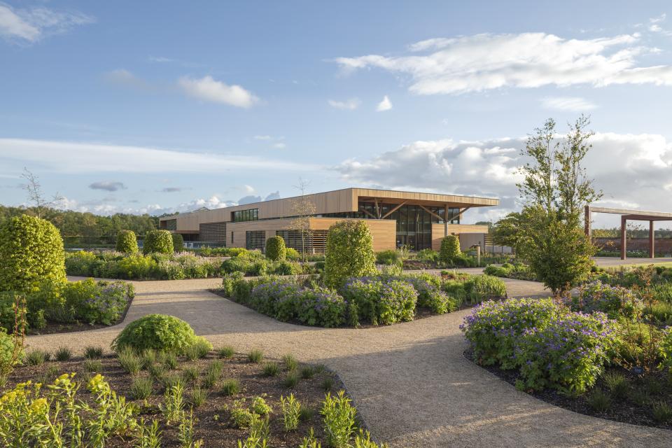 Elegant RHS Bridgewater building surrounded by lush gardens and winding pathways showcasing Allgood's Modric range.