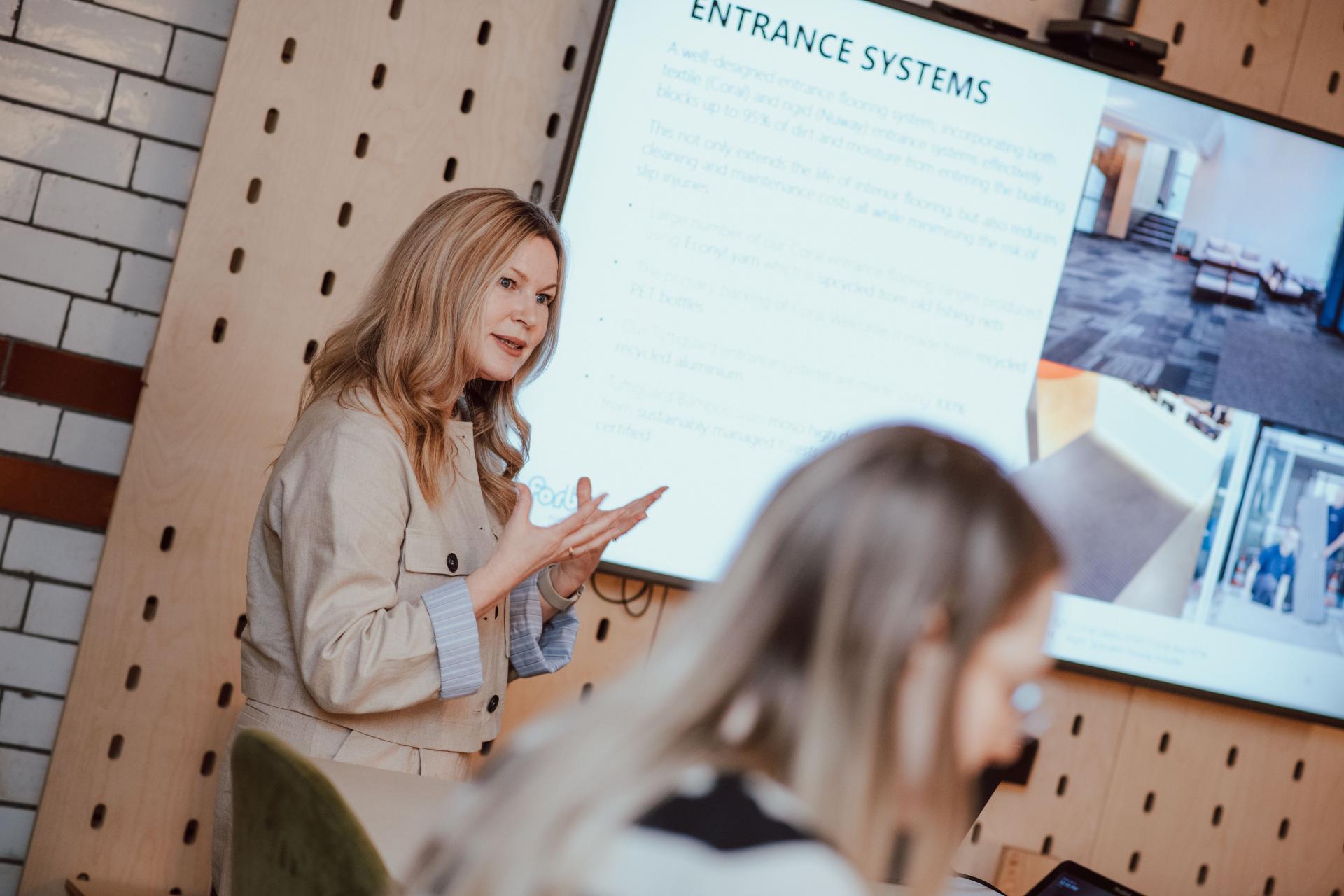 Creative presentation on interior design concepts, featuring a speaker discussing entrance systems with students at Manchester Academy.