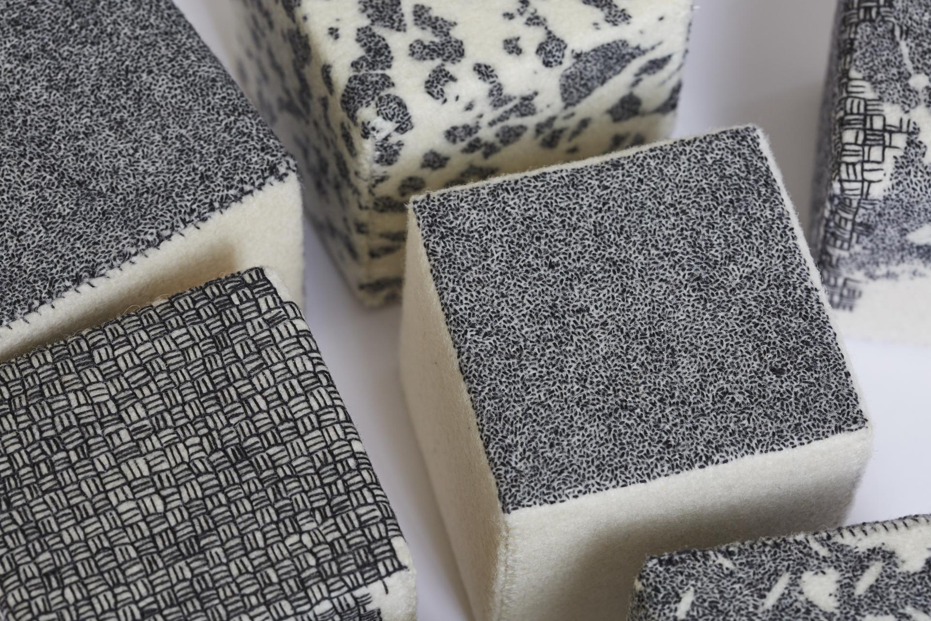 Handcrafted fabric cubes featuring unique monochrome patterns, showcasing Louisa Pacifico's focus on craft and materials at Future Icons.