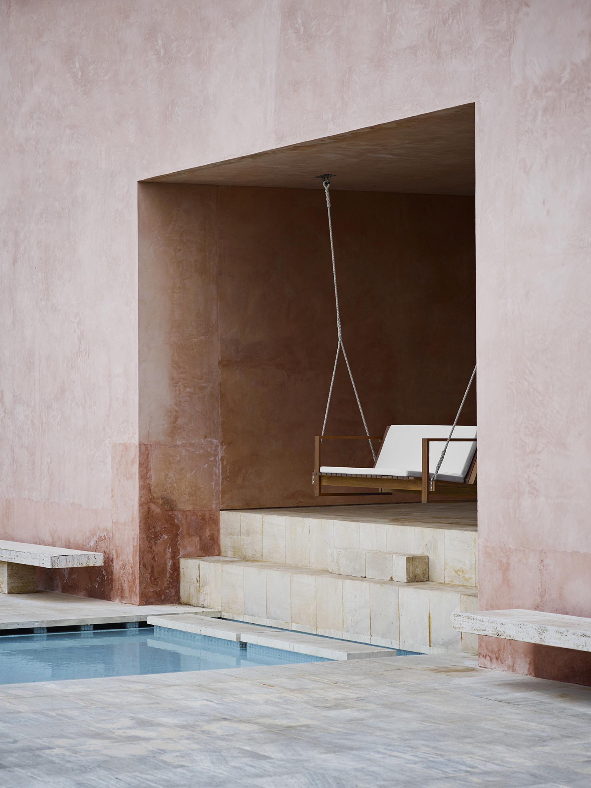 Bodil Kjær-designed architectural furniture showcased in a serene outdoor space, featuring a swing and minimalist aesthetics.