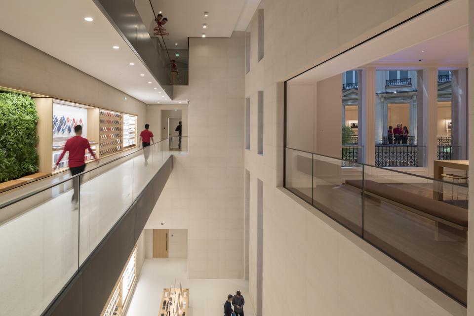 Interior view of Apple's Champs-Élysées store featuring modern design elements and customers browsing products.