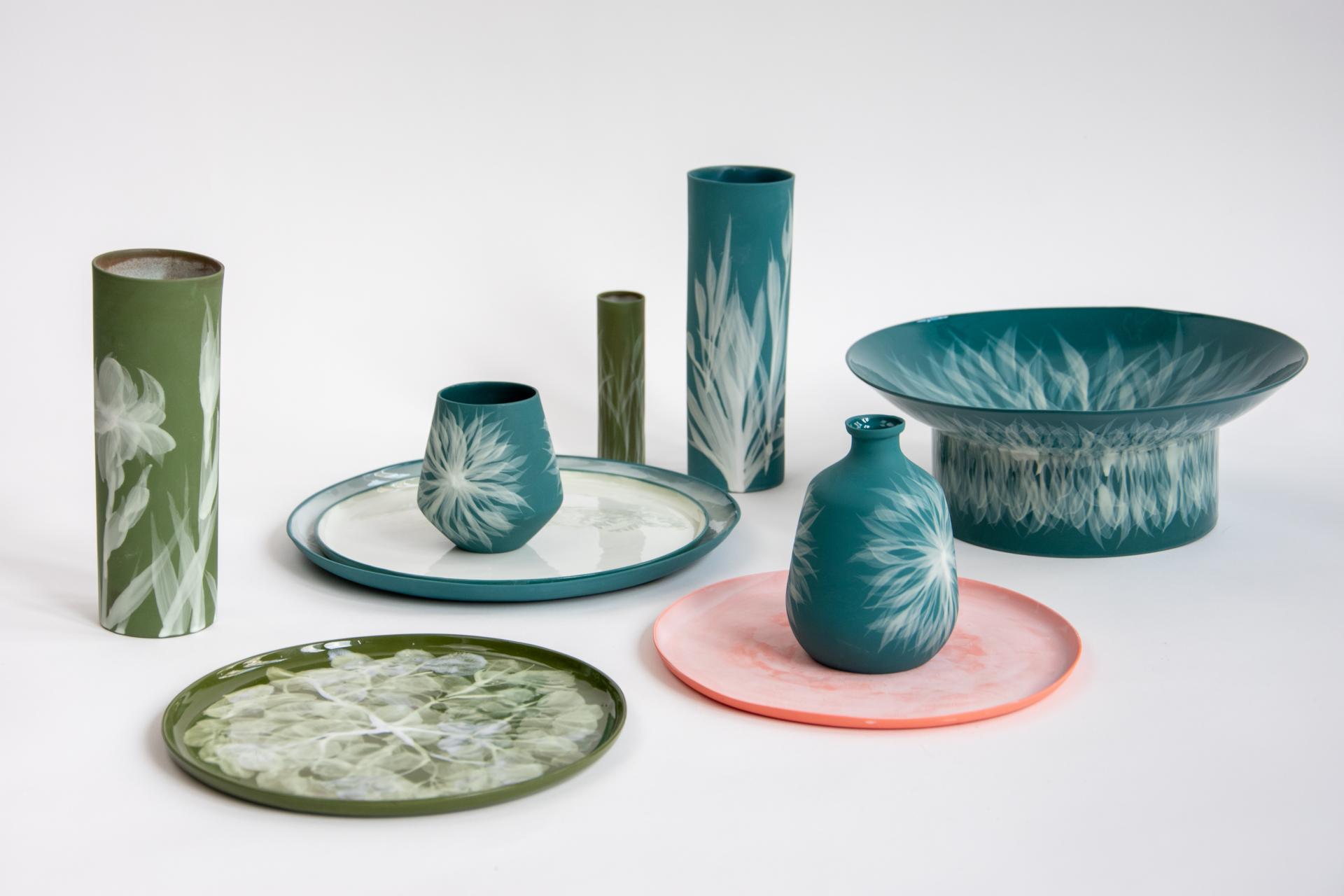 Ceramic pieces by Reiko Kaneko, showcasing intricate floral designs in various colors and shapes.