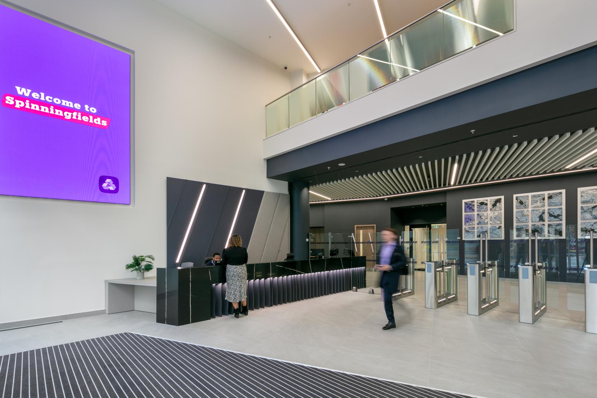 Modern office reception area in Spinningfields, Manchester, showcasing a welcoming design and sleek architecture elements.