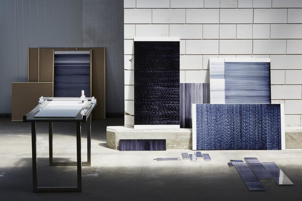 Innovative tile designs by Léa Mazy displayed on a table, showcasing a new printing process for the tile industry.