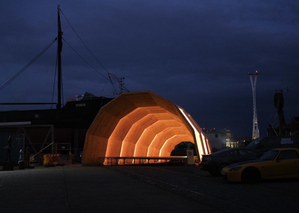 Eucalyptus CLT structure, The Armadillo, illuminated at night, showcasing innovative architectural design by Unknown Works.