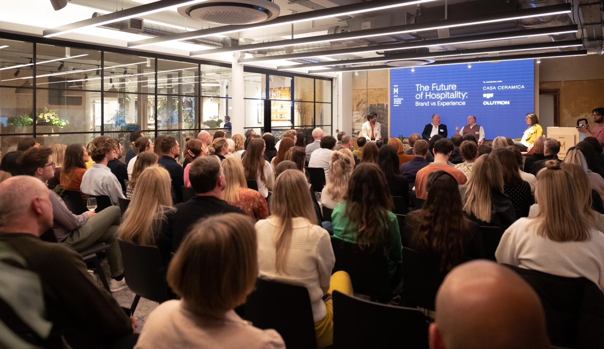 Audience engaged in a seminar discussing the future of hospitality, featuring a panel on brand versus experience.