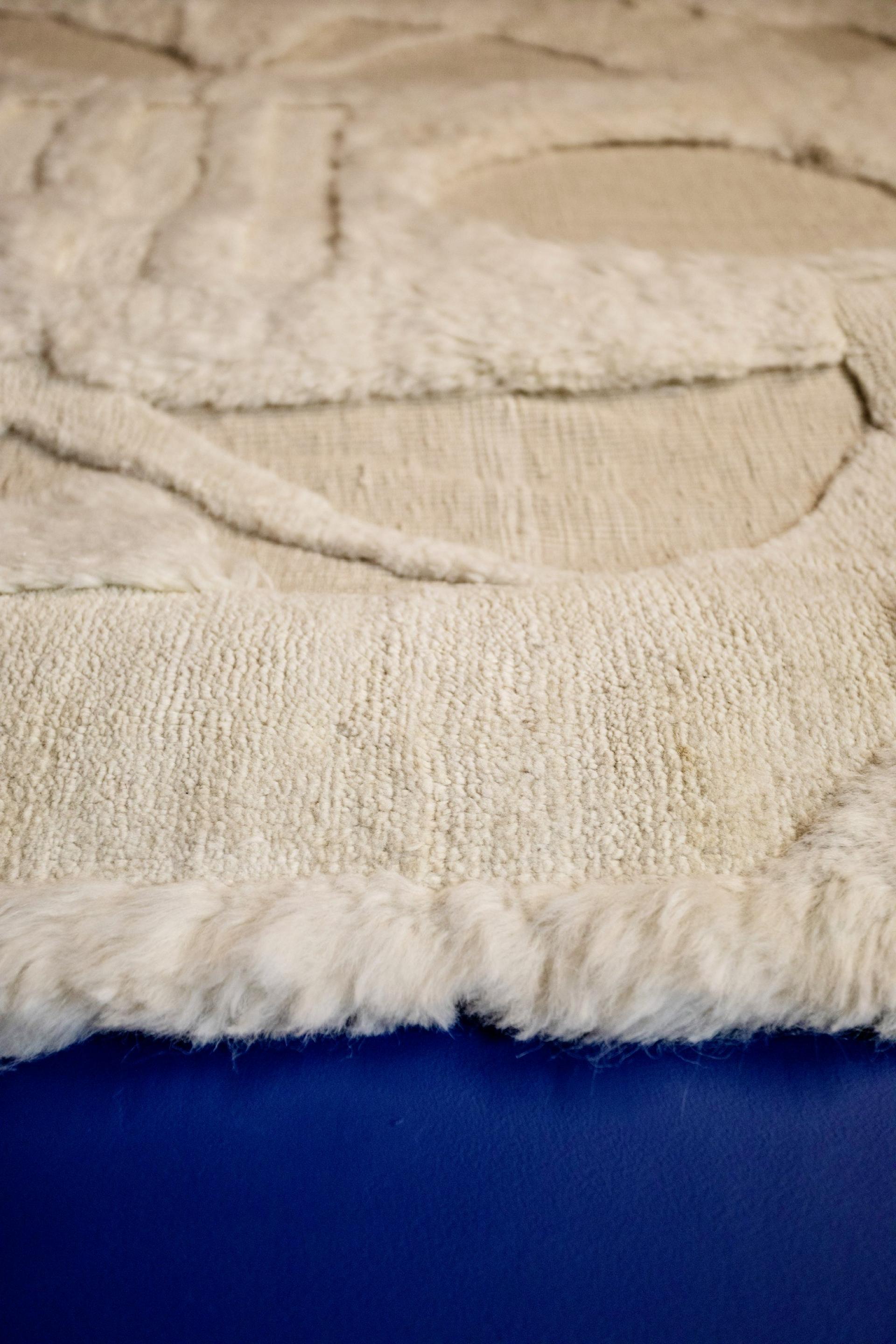 Textured textile artwork by Dharma Taylor, showcasing intricate patterns and soft fibers, highlighting the narrative of materials.