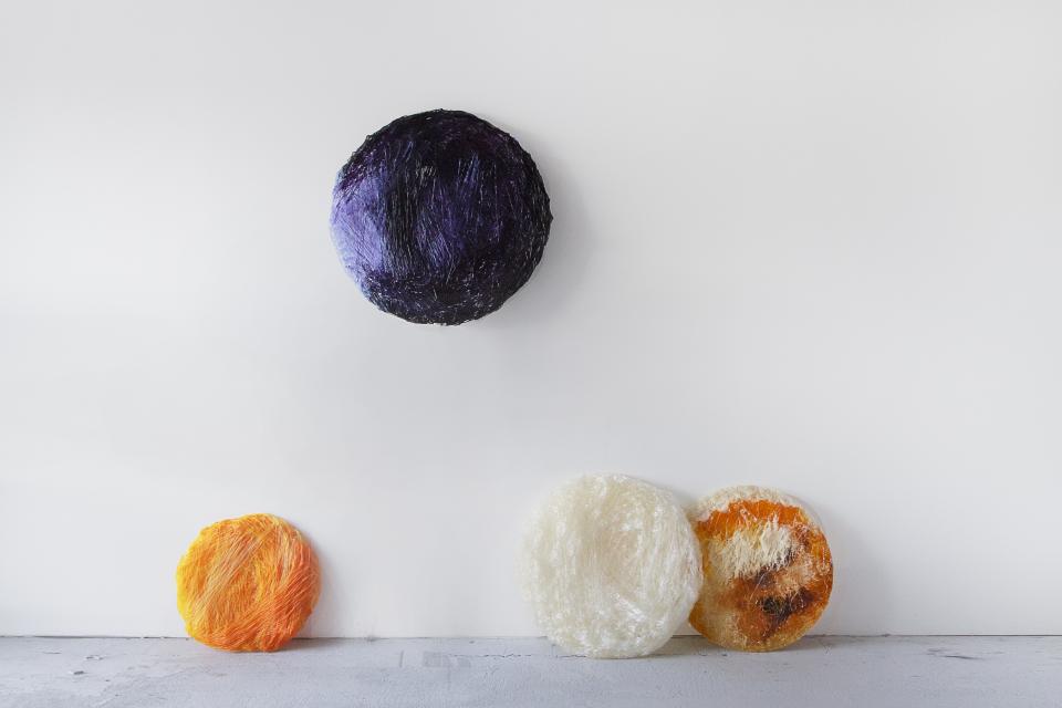 Colorful circular bioplastic samples made from Nuatan, showcasing biodegradable materials for sustainable design and environmental safety.