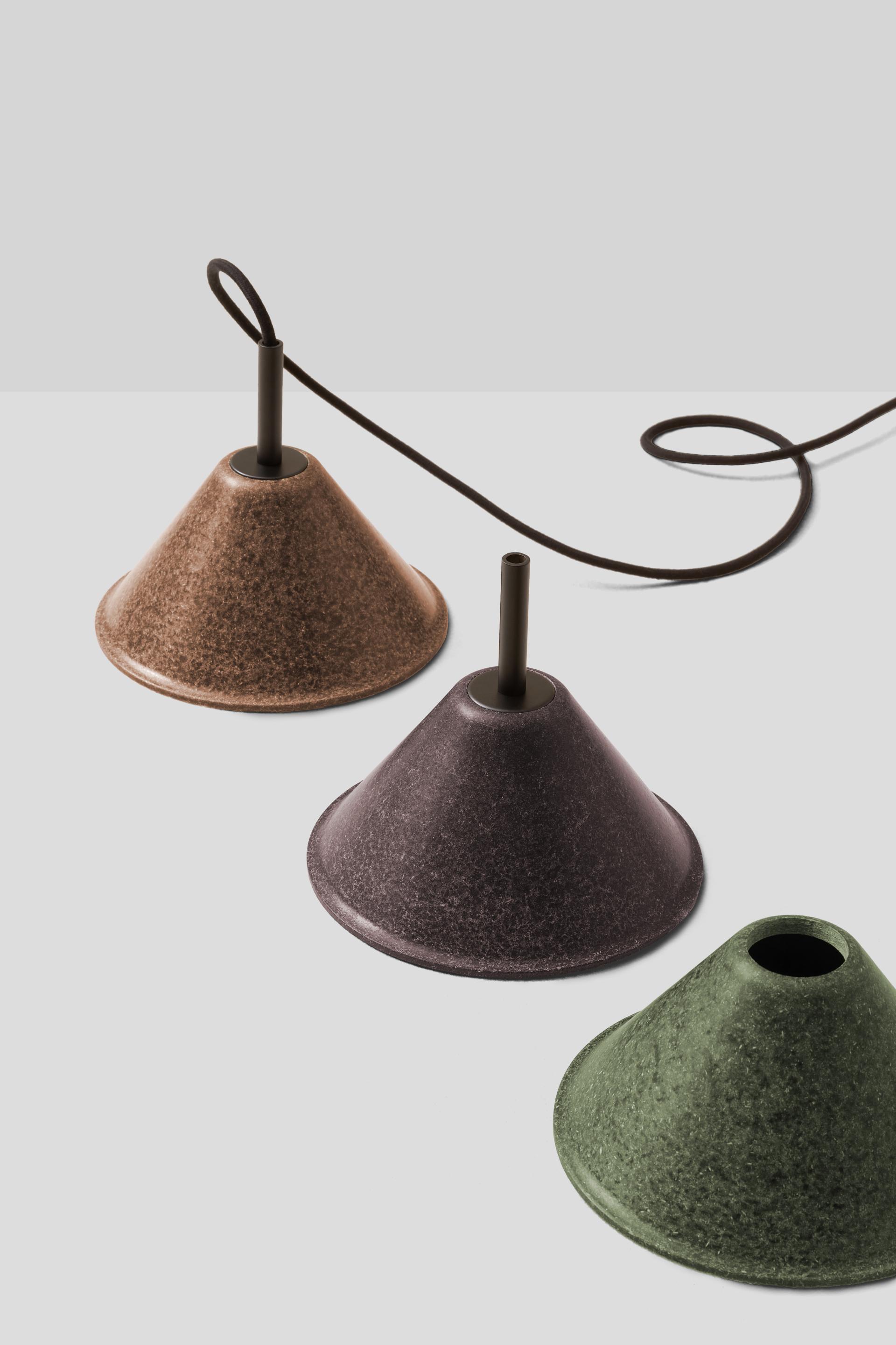 Sustainable lighting design showcasing conical lamps in earthy tones, emphasizing eco-friendly materials and innovative aesthetics.