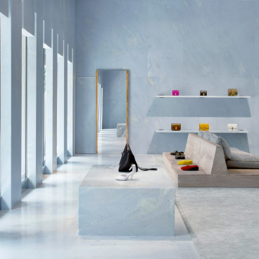 Céline's Miami store interior features blue marble surfaces, pyramid shapes, and luxury handbags on display.