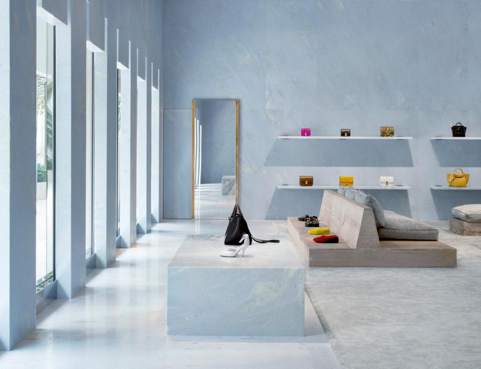 Céline's Miami store interior features blue marble surfaces, pyramid shapes, and luxury handbags on display.