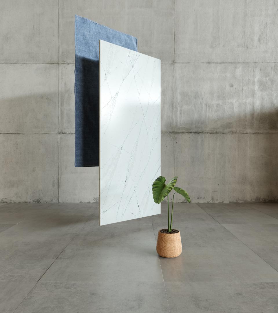 Silestone® Ethereal surface displayed alongside textured fabric and a potted plant in a contemporary interior setting.