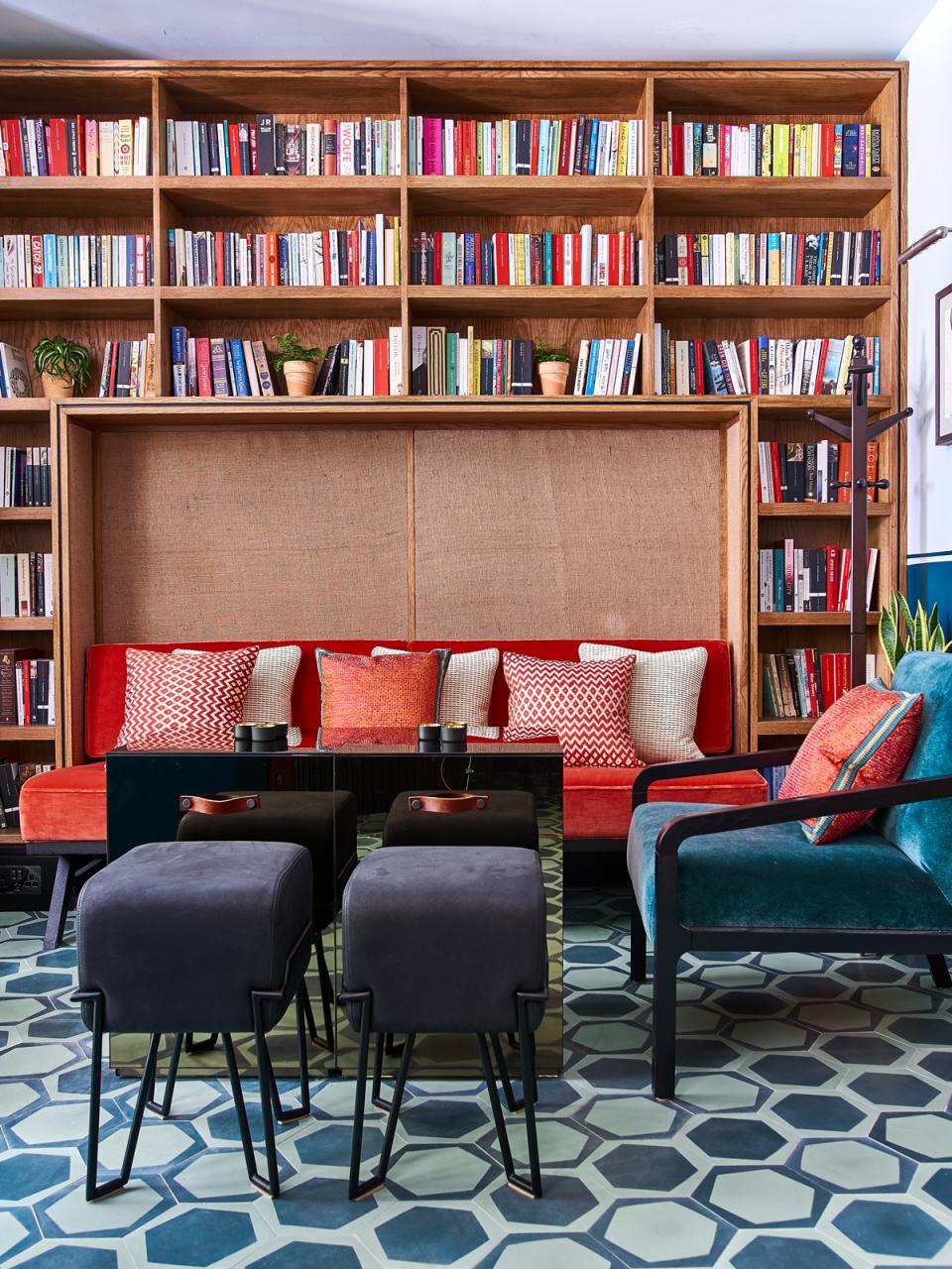 Stylish art deco interior of Teatulia’s tea shop, featuring colorful seating, book shelves, and geometric floor tiles.