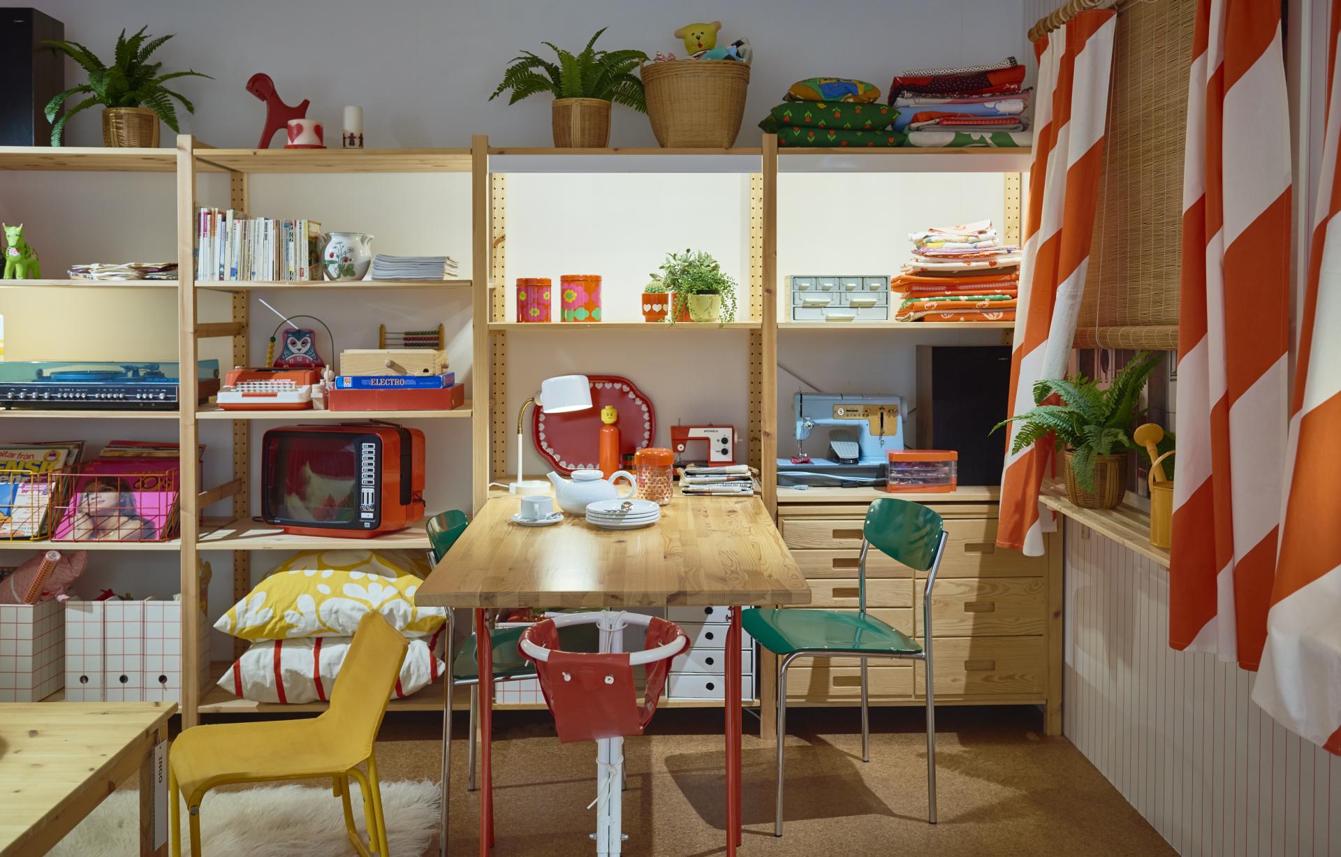 Colorful IKEA-inspired dining area featuring modern furniture, shelves filled with decor items, and home accessories.