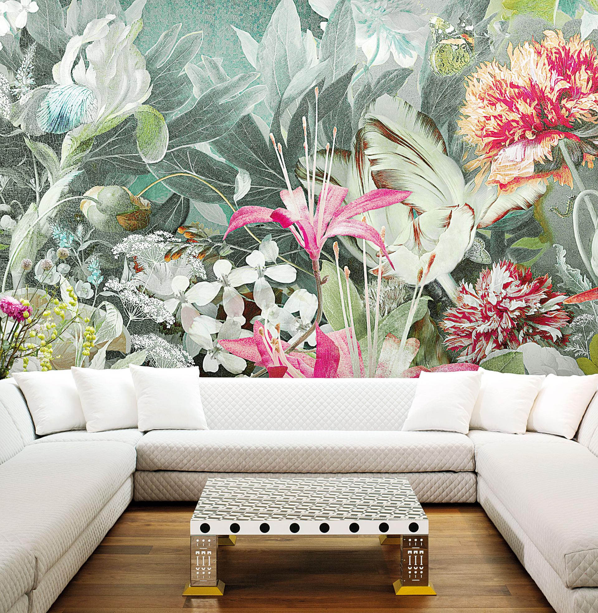Vibrant floral wallpaper by Marcel Wanders decorates a modern living room with sleek furniture and a stylish coffee table.