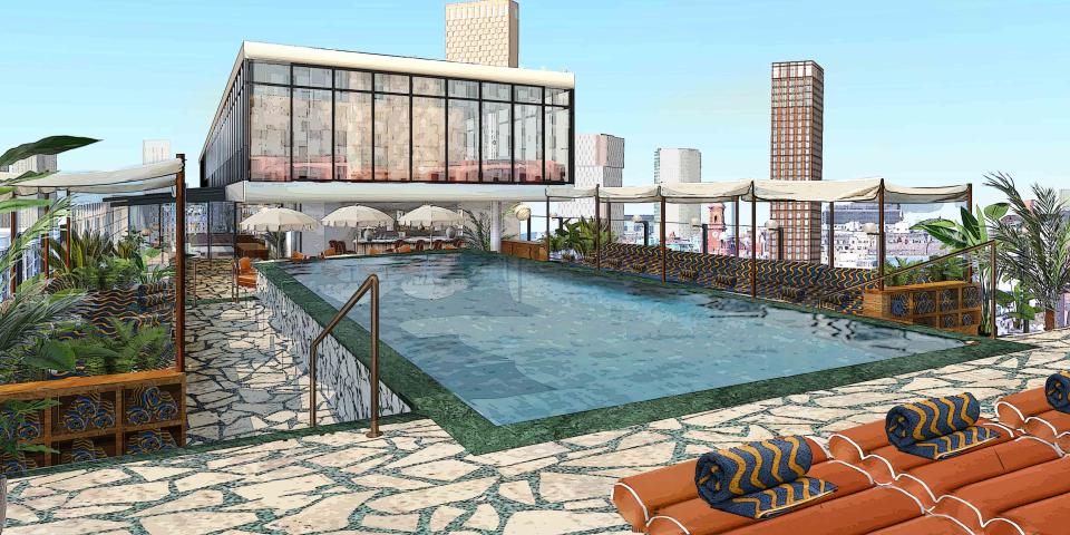 Soho House Manchester rooftop pool area featuring a luxurious pool with seating and views of the city skyline.
