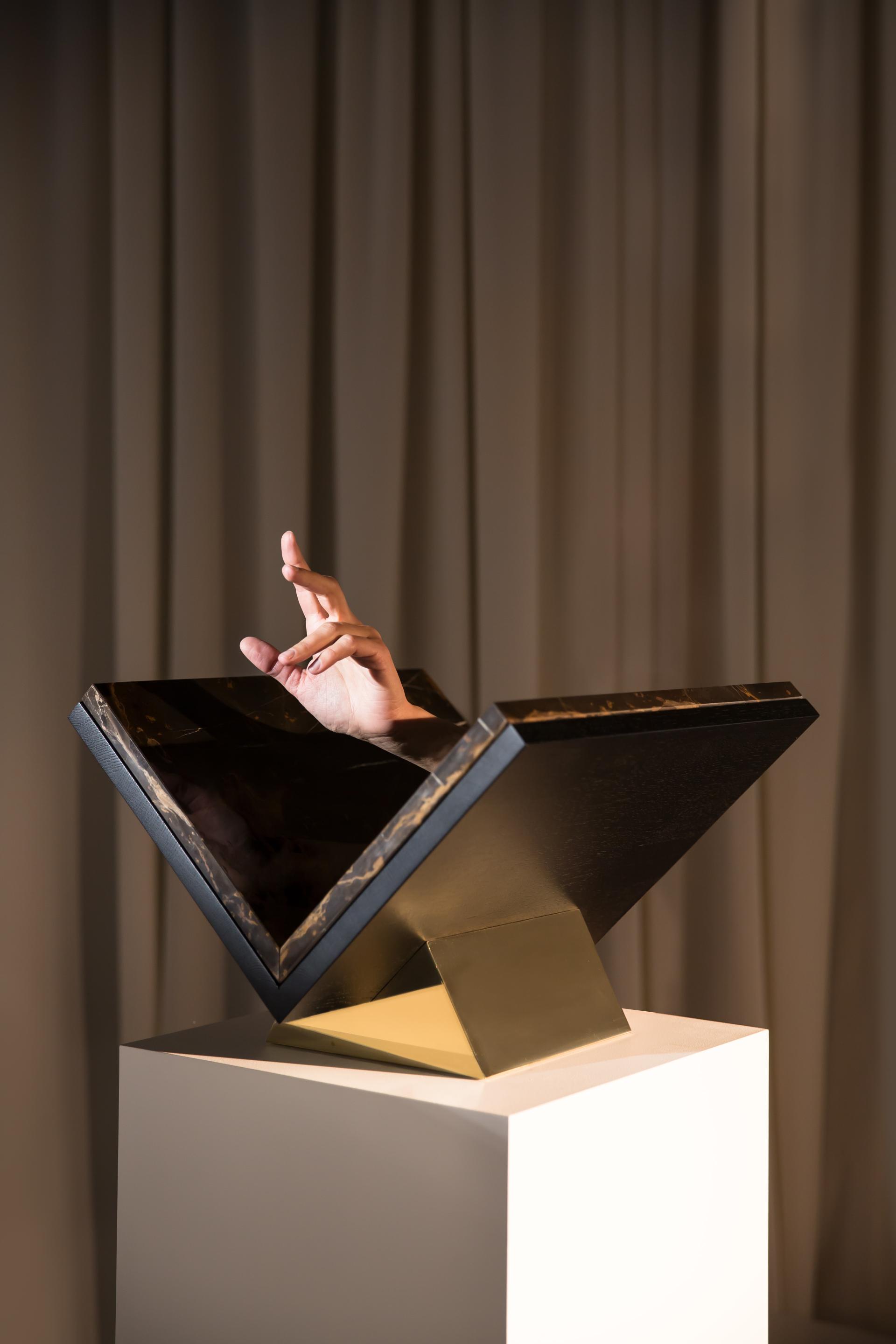 Artistic black and gold design piece showcased on a pedestal, symbolizing contemporary German design innovation and craftsmanship.